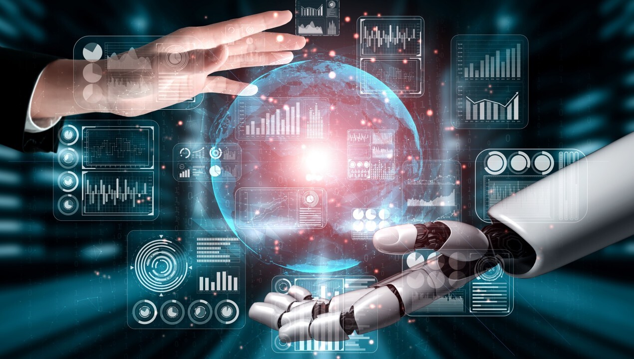 A human hand and robot hand connecting over digital data dashboards, symbolising AI-human collaboration, machine learning and automation in business.